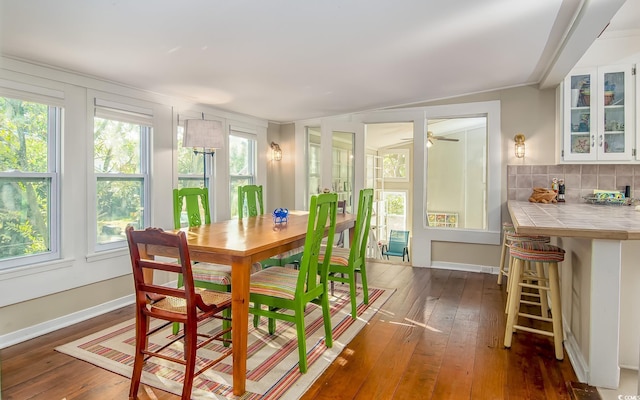 dining area with ceiling fan and dark wood-type flooring