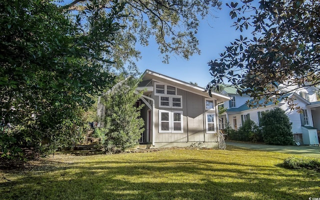 view of property exterior with a lawn