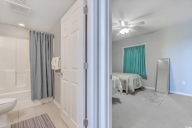 bathroom with toilet, a textured ceiling, shower / tub combo with curtain, and ceiling fan