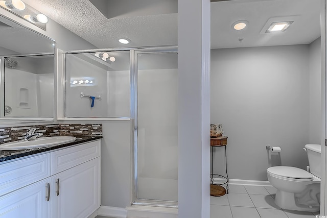 bathroom featuring tasteful backsplash, tile patterned floors, a textured ceiling, vanity, and a shower with shower door