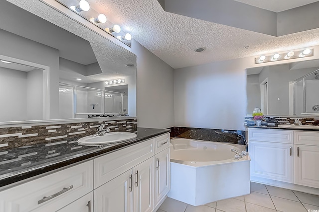 bathroom with backsplash, tile patterned floors, a textured ceiling, vanity, and plus walk in shower