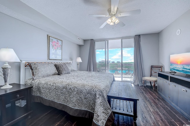 bedroom with a textured ceiling, access to outside, ceiling fan, and dark hardwood / wood-style floors