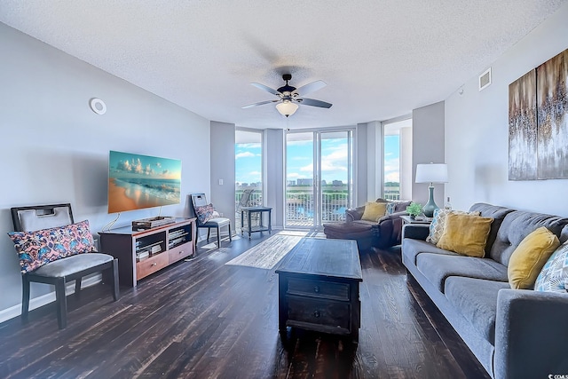 living room featuring dark hardwood / wood-style flooring, a textured ceiling, expansive windows, and ceiling fan