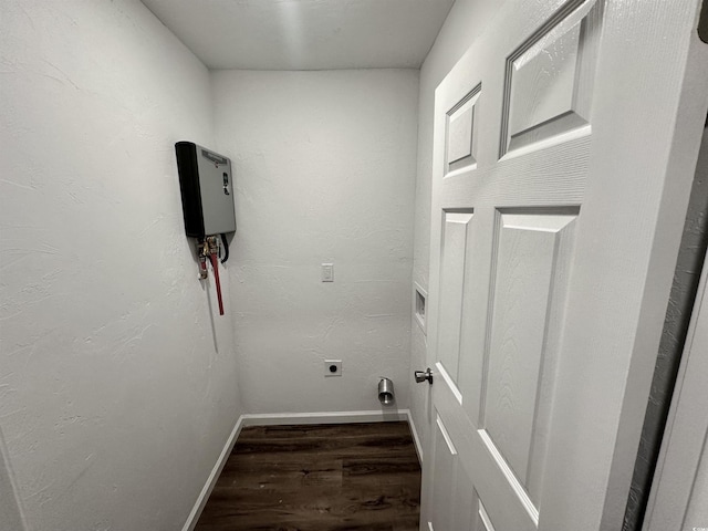 laundry room featuring electric dryer hookup and dark hardwood / wood-style flooring