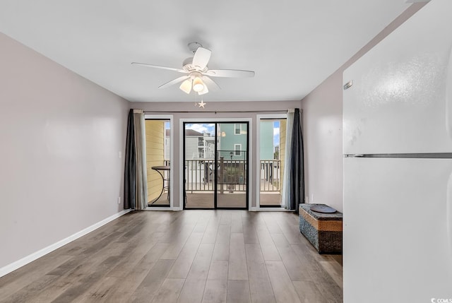 spare room with hardwood / wood-style floors and ceiling fan