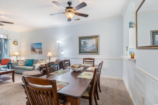 dining room featuring carpet flooring, ceiling fan, and crown molding