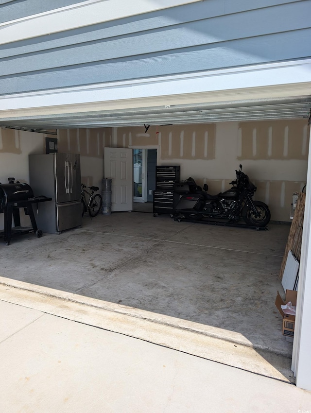 2023 Singing Palm Loop, Little River, SC 29566 - garage featuring freestanding refrigerator