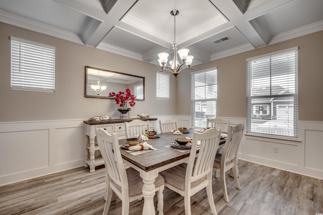 dining room featuring a chandelier, a wainscoted wall, and beamed ceiling