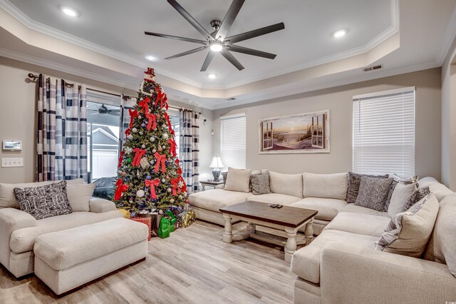 2023 Singing Palm Loop, Little River, SC 29566 - living room with ceiling fan, a raised ceiling, ornamental molding, light wood-style floors, and recessed lighting