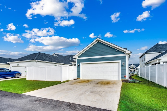 view of front facade with an attached garage, fence, a front lawn, and concrete driveway