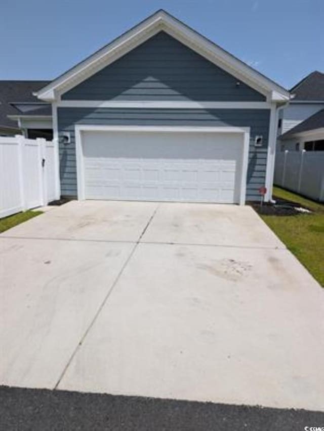 2023 Singing Palm Loop, Little River, SC 29566 - ranch-style house featuring fence, concrete driveway, and an attached garage