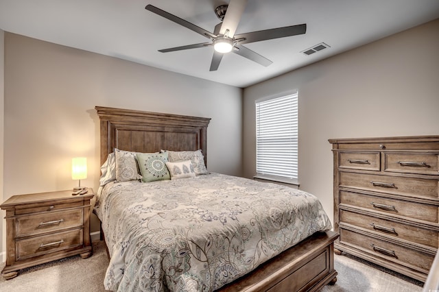 bedroom with visible vents, ceiling fan, and light carpet