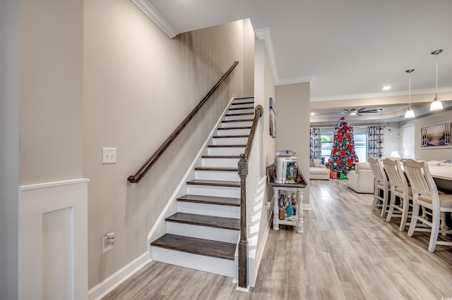 2023 Singing Palm Loop, Little River, SC 29566 - staircase featuring wood finished floors, ornamental molding, ceiling fan, and baseboards