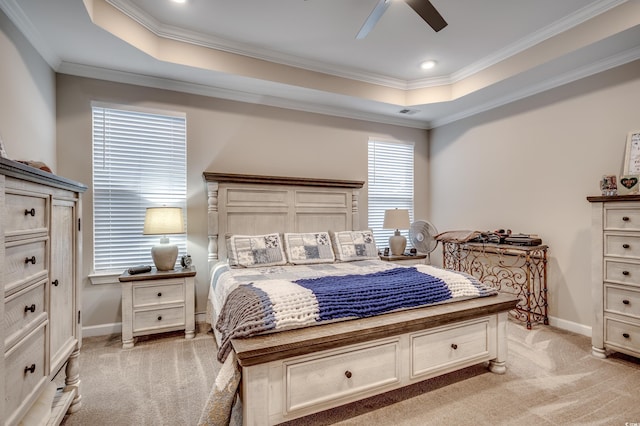 bedroom with light carpet, crown molding, a raised ceiling, and baseboards