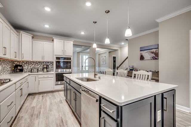 2023 Singing Palm Loop, Little River, SC 29566 - kitchen with a sink, stainless steel appliances, gray cabinetry, a center island with sink, and light countertops