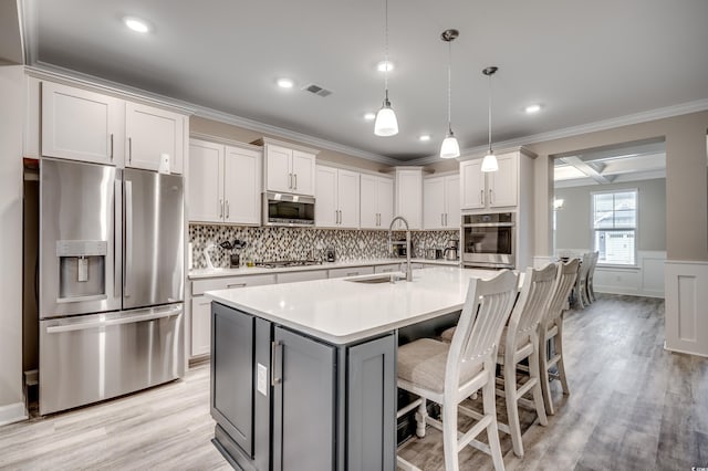 2023 Singing Palm Loop, Little River, SC 29566 - kitchen featuring stainless steel appliances, a sink, crown molding, light countertops, and backsplash
