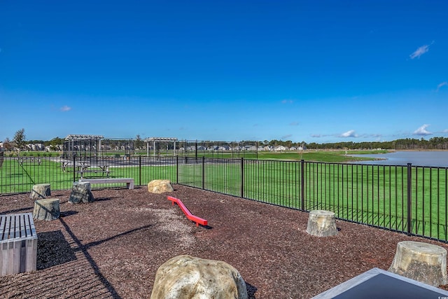 view of yard featuring playground community and fence