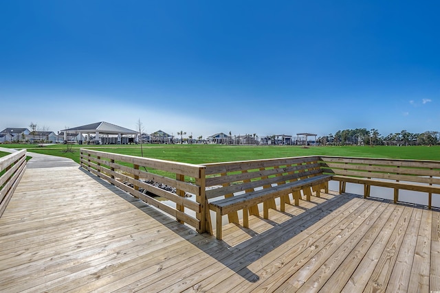 view of dock with a lawn and a residential view