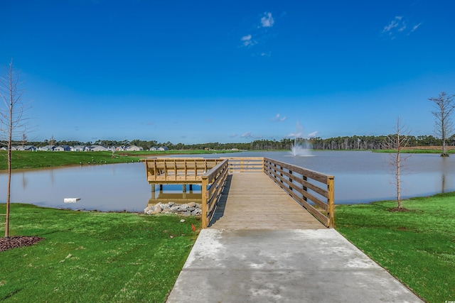 dock area with a water view and a lawn