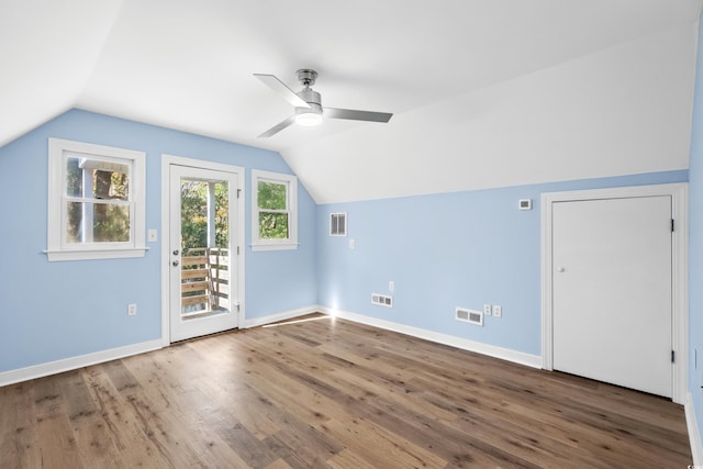 additional living space featuring hardwood / wood-style flooring, ceiling fan, and vaulted ceiling