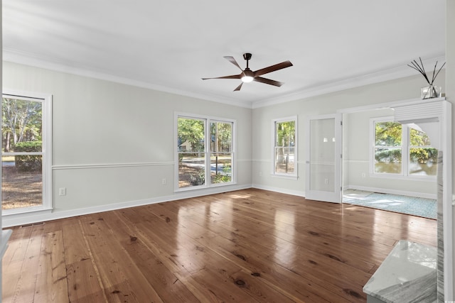 unfurnished room with hardwood / wood-style flooring, a healthy amount of sunlight, and crown molding