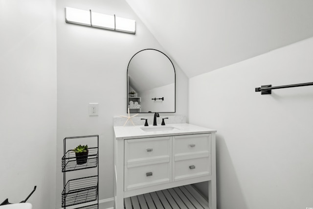 bathroom featuring vanity and vaulted ceiling