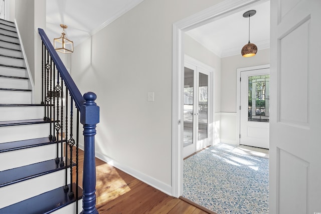 entrance foyer with hardwood / wood-style floors, french doors, and crown molding