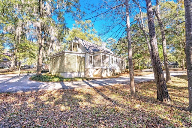 view of side of property featuring a sunroom