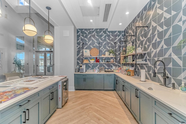 bar featuring pendant lighting, tasteful backsplash, recessed lighting, a sink, and beverage cooler