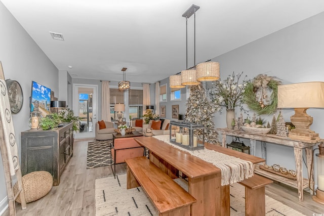 dining space featuring visible vents and light wood-style floors