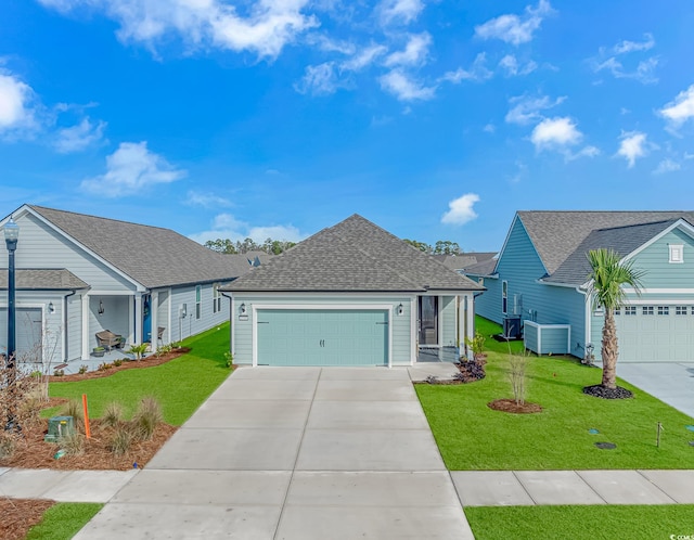 ranch-style home with a garage, driveway, a shingled roof, and a front yard