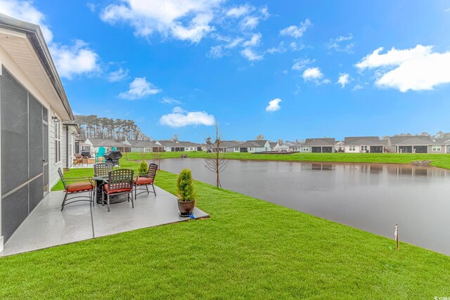 back of property with a sunroom, a patio, and a lawn