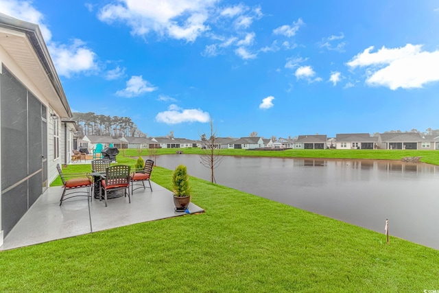 view of yard featuring a patio, a water view, and a residential view