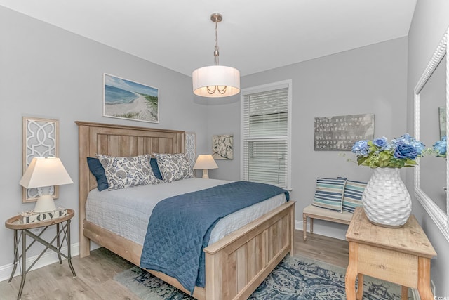 bedroom with light wood-style floors and baseboards