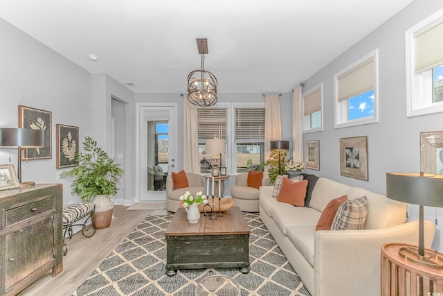 living area with a chandelier and light wood-type flooring