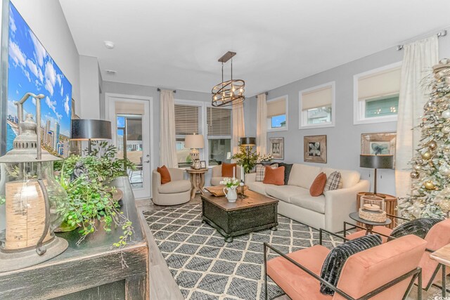 living room featuring sink, hardwood / wood-style floors, and an inviting chandelier