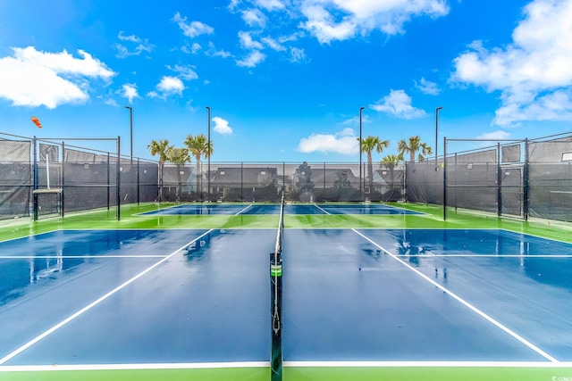 view of tennis court featuring fence