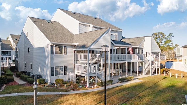 back of house featuring a lawn, a wooden deck, a patio area, and central air condition unit