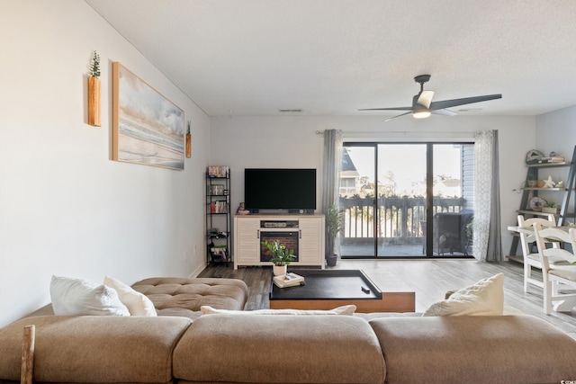 living room with hardwood / wood-style flooring and ceiling fan