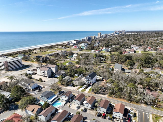 aerial view with a water view and a beach view