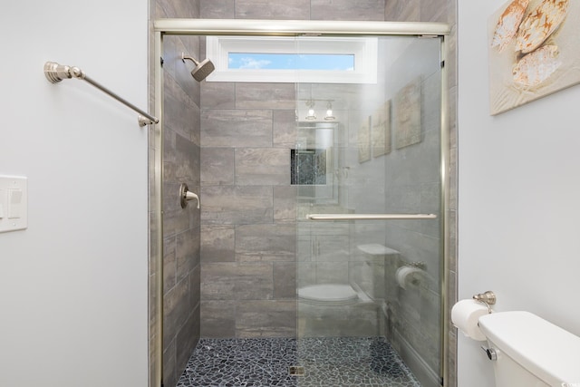 bathroom with an enclosed shower and toilet