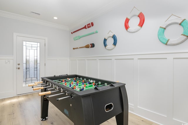 playroom featuring light wood-type flooring and ornamental molding