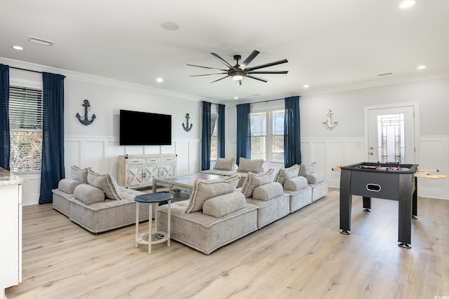 living room featuring ceiling fan, light hardwood / wood-style floors, and ornamental molding