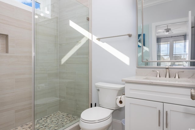 bathroom with vanity, a wealth of natural light, ceiling fan, and toilet