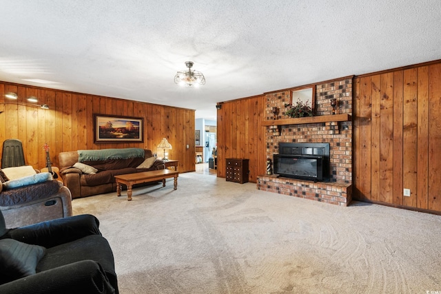 living room with a textured ceiling, a fireplace, wood walls, and light carpet