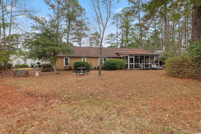 rear view of house featuring a sunroom