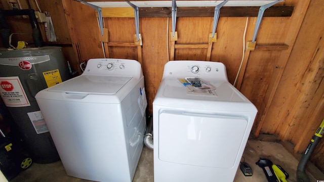 washroom with washer and clothes dryer and water heater