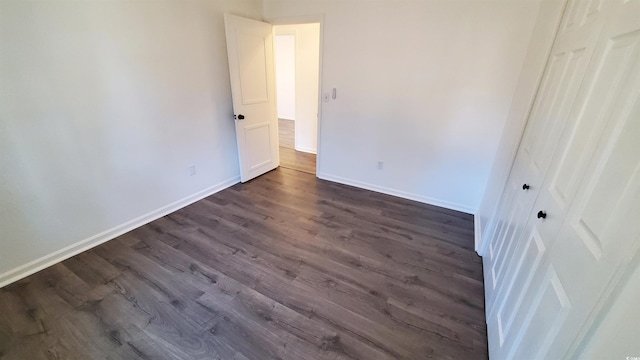 unfurnished bedroom with dark hardwood / wood-style floors