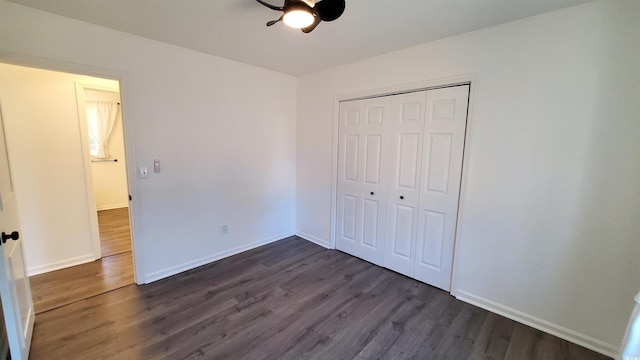 unfurnished bedroom featuring a closet, ceiling fan, and dark hardwood / wood-style floors