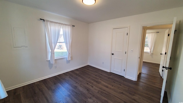 unfurnished bedroom featuring dark hardwood / wood-style flooring and a closet